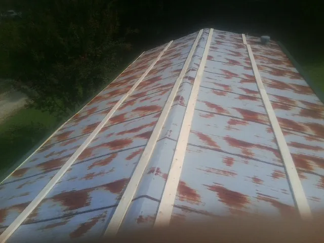 Rusted metal roof panels with new wood purlins before replacement — Storm Damage Roof Repair in Ibapah by Roofing Brothers