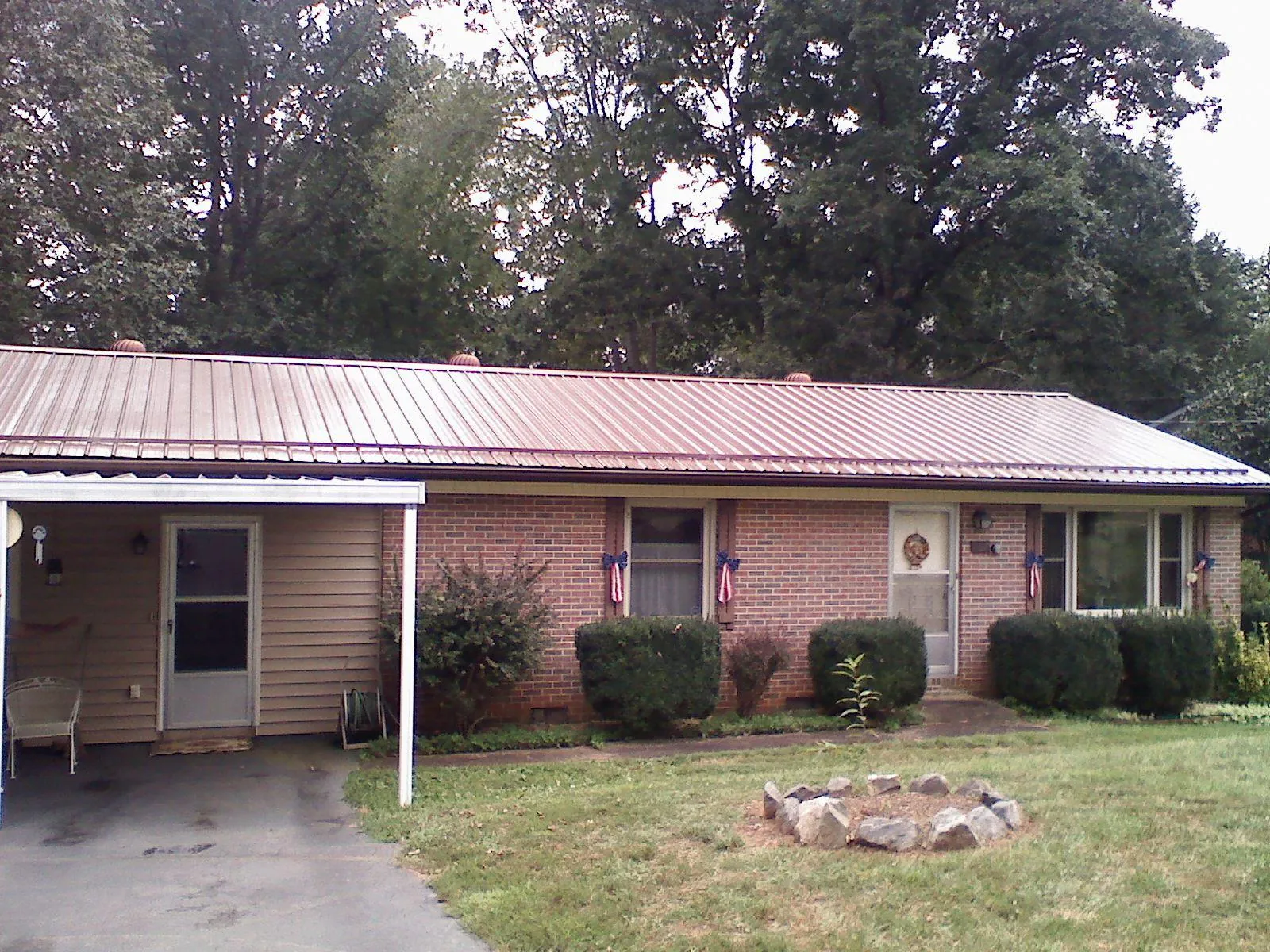 Bronze metal roof and carport on a brick ranch home — Roof Repair work by our crew in Ibapah